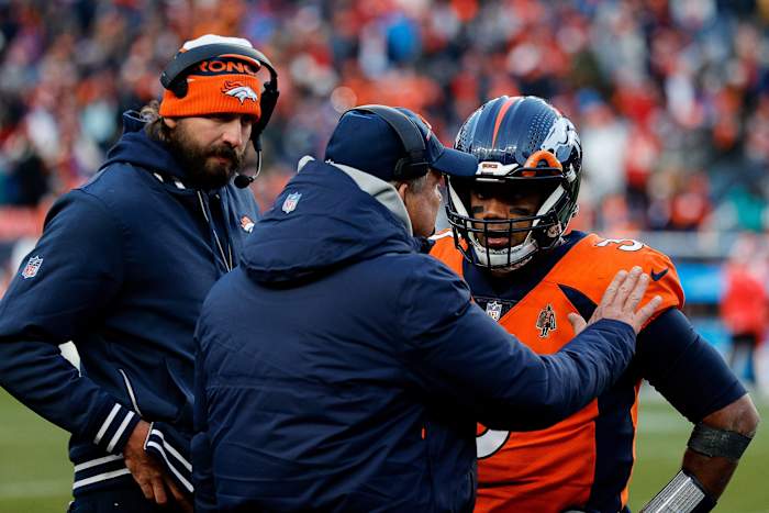 Denver Broncos head coach Sean Payton talks with quarterback Russell Wilson (3) and quarterbacks coach Davis Webb in the fourth quarter against the Kansas City Chiefs at Empower Field at Mile High.